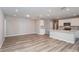 Spacious living area adjacent to a modern kitchen, featuring sleek floors and recessed lighting at 6822 Sw 90Th Loop, Ocala, FL 34476