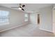 Spacious carpeted bedroom with ceiling fan and walk-in closet at 1509 Sweet Apple St, Oakland, FL 34787