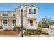 Two-story townhome with red door and landscaped front yard at 1509 Sweet Apple St, Oakland, FL 34787