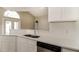 Well-lit kitchen featuring stainless steel appliances, white cabinets, and quartz countertops at 2504 Davenport Cir, Kissimmee, FL 34746