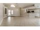 Bright living area with tile flooring, high ceilings, and an open floor plan connecting to the kitchen at 2504 Davenport Cir, Kissimmee, FL 34746