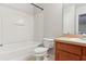 Clean bathroom, featuring a tub shower combo, toilet and wood vanity at 2804 Grasmere View Pkwy, Kissimmee, FL 34746