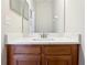 Bathroom with a quartz vanity top and wood cabinets at 2804 Grasmere View Pkwy, Kissimmee, FL 34746