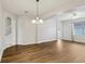 Dining room with hardwood floors, chandelier, and access to the kitchen at 2804 Grasmere View Pkwy, Kissimmee, FL 34746