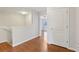 Upstairs hallway with wood floors and access to bedrooms at 2804 Grasmere View Pkwy, Kissimmee, FL 34746