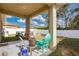 Covered patio with seating area, overlooking fenced backyard with pool at 3723 Madbury Cir, Lakeland, FL 33810