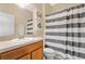 Bathroom with a single sink and striped shower curtain at 3723 Madbury Cir, Lakeland, FL 33810