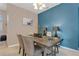 Dining room with dark wood table and blue accent wall at 3723 Madbury Cir, Lakeland, FL 33810