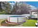 Round above-ground pool with landscaped border in backyard at 3723 Madbury Cir, Lakeland, FL 33810