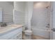 Clean white bathroom with a shower-tub combo, white subway tile, and a modern vanity with marble countertop at 6785 Sw 90Th Loop, Ocala, FL 34476