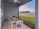 Outdoor patio with a dining table, chairs, and a view of the backyard and a white vinyl fence at 6785 Sw 90Th Loop, Ocala, FL 34476