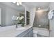 Well-appointed bathroom with gray vanity, quartz countertop, tub-shower combination, and modern fixtures at 6801 Sw 90Th Loop, Ocala, FL 34476