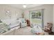 Charming Bedroom with a crib, rocking chair, and ample natural light at 209 W Highland St, Lakeland, FL 33803