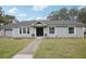 Newly renovated house with gray siding, new landscaping and a two-car garage at 209 W Highland St, Lakeland, FL 33803