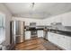 Kitchen features white cabinets, stainless steel appliances, and wood floors at 209 W Highland St, Lakeland, FL 33803