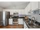 Bright kitchen featuring stainless steel appliances and white cabinetry at 209 W Highland St, Lakeland, FL 33803