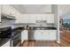 Modern kitchen with stainless steel appliances and white cabinets at 209 W Highland St, Lakeland, FL 33803