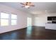 Spacious living room with dark hardwood floors and sliding glass doors at 430 Stillwater Ln, Haines City, FL 33844