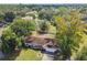 Residential area featuring single Gathering homes with mature landscaping, trees, and a nearby lake view at 683 Anderson Dr, Deltona, FL 32725