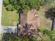 Aerial view of a home with a brown roof, surrounded by a well-manicured lawn and mature trees at 683 Anderson Dr, Deltona, FL 32725