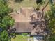 A bird's eye view of a home with a brown roof, surrounded by greenery, and a well-kept landscape at 683 Anderson Dr, Deltona, FL 32725