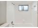 Clean white tiled shower/bath with shower head and small window providing natural light at 683 Anderson Dr, Deltona, FL 32725