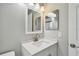 Bright bathroom with a modern vanity, ample lighting, and sleek fixtures at 683 Anderson Dr, Deltona, FL 32725