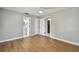 Bedroom featuring wood-look floors, ceiling fan, and multiple doorways at 683 Anderson Dr, Deltona, FL 32725