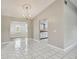 A dining room with tile floors that leads to a kitchen at 683 Anderson Dr, Deltona, FL 32725