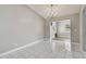 Dining room featuring tile floors, chandelier and grey walls at 683 Anderson Dr, Deltona, FL 32725