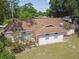 Exterior of a single-story home with a brown roof, well-maintained lawn, and complemented by arched windows at 683 Anderson Dr, Deltona, FL 32725