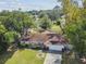 A beautiful single-Gathering home featuring lush landscaping, mature trees, and a private driveway at 683 Anderson Dr, Deltona, FL 32725