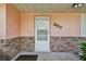 Inviting front porch featuring brick accents and a modern storm door at 683 Anderson Dr, Deltona, FL 32725