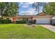 Charming single-story home with a well-manicured lawn and a two-car attached garage at 683 Anderson Dr, Deltona, FL 32725