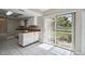 Bright kitchen featuring white cabinets, wood counters, and sliding glass doors to the backyard at 683 Anderson Dr, Deltona, FL 32725