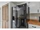 Kitchen featuring a modern black refrigerator, wood countertops and pantry storage at 683 Anderson Dr, Deltona, FL 32725