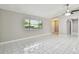 Bright living room featuring modern tile floors and a large window for natural light at 683 Anderson Dr, Deltona, FL 32725