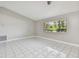 Bright living room featuring modern tile floors and a large window for natural light at 683 Anderson Dr, Deltona, FL 32725