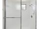 Tiled shower featuring glass doors and updated fixtures, providing a clean and modern bathing experience at 683 Anderson Dr, Deltona, FL 32725