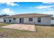 Home's back exterior, showing patio and yard at 1371 Laurel Glen Dr, Bartow, FL 33830