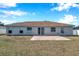 Home's back exterior, showing patio and yard at 1371 Laurel Glen Dr, Bartow, FL 33830