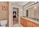 Double vanity bathroom with granite counters and view of bedroom at 1371 Laurel Glen Dr, Bartow, FL 33830