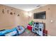 bedroom with toys, play area, and a TV at 1371 Laurel Glen Dr, Bartow, FL 33830