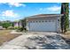 House exterior featuring a two-car garage and a well-maintained yard at 1371 Laurel Glen Dr, Bartow, FL 33830