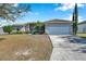 Single story house with a two-car garage and a neatly kept lawn at 1371 Laurel Glen Dr, Bartow, FL 33830