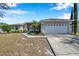 Single-story home with a two-car garage and landscaped yard at 1371 Laurel Glen Dr, Bartow, FL 33830