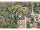 Aerial view showcasing home's location in a wooded area at 11730 Sw 230Th Avenue Rd, Dunnellon, FL 34431