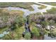 Aerial view of canal-front property with lush trees at 11730 Sw 230Th Avenue Rd, Dunnellon, FL 34431