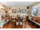 Charming dining room features hardwood floors and antique table at 11730 Sw 230Th Avenue Rd, Dunnellon, FL 34431