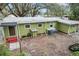 Green house exterior with AC units and landscaping at 11730 Sw 230Th Avenue Rd, Dunnellon, FL 34431